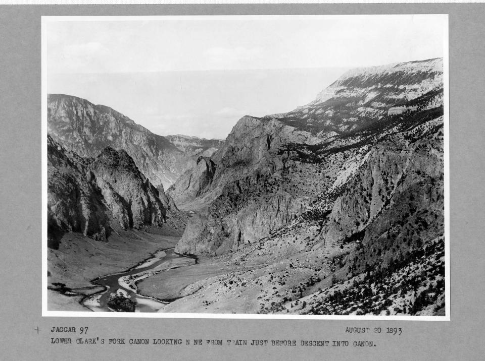 black and white photo looking down into a riverbed and meadow from high up
