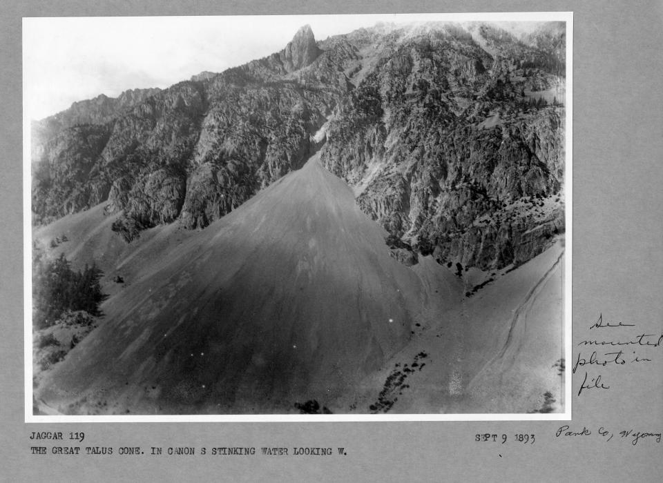back and white photo of rugged canyon with an enormous talus field spilling out into the valley below