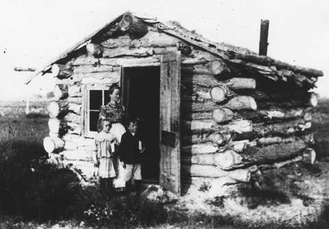 Annie Chamberlain Powers and her children Laura and John outside their sod-roofed house, built in 1905 near Lingle. Homesteader Museum.