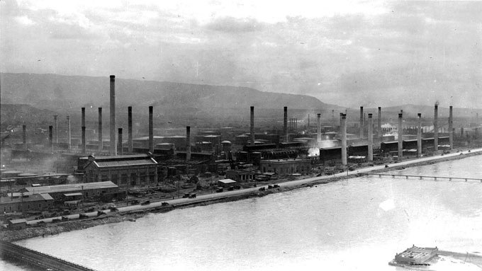 The Midwest Oil Company Refinery in Casper, shown here around 1920 with  the North Platte River in the foreground, was later bought by Standard  Oil. Blackmore Collection, Casper College Western History Center.