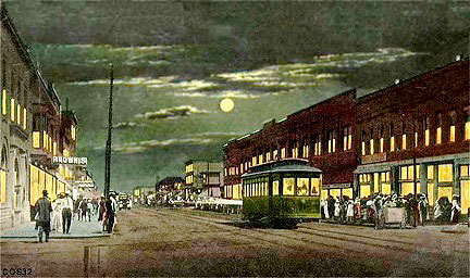 Sheridan at night, in a colorized daytime image with a false moonlit sky, featuring the Sheridan Railway Company streetcar.