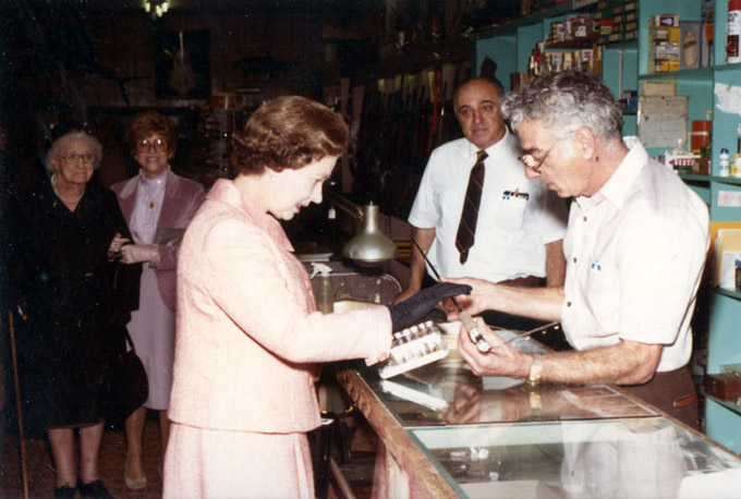 Sam Mavrakis rings up a sale to Queen Elizabeth II at the Ritz Sporting Goods in Sheridan, 1984. Sheridan County Museum.