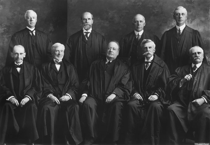 The Supreme Court at the time United States v. Midwest Oil was decided. Willis Van Devanter of Wyoming is second from the right in the back row. Collection of the Supreme Court of the United States.