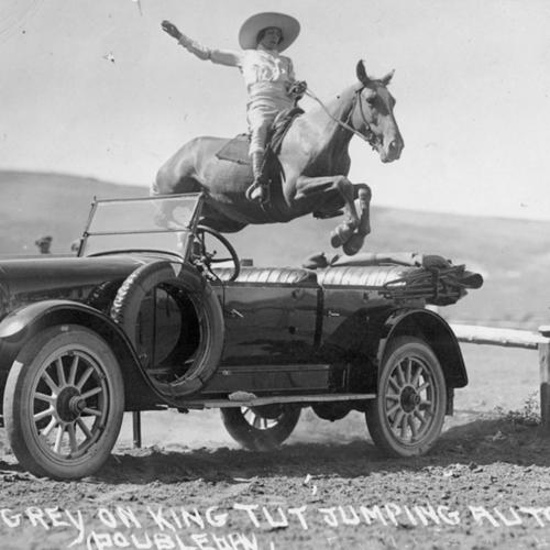Bonnie Gray, on King Tut, jumps a car in Wyoming in the mid 1920s. Wyoming State Archives. 