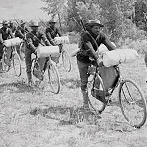 soldiers riding bicycles across the plains