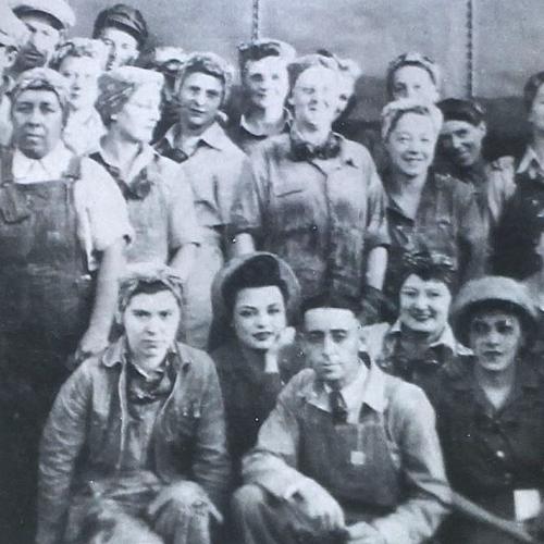group shot of many men and women in overalls and work clothing