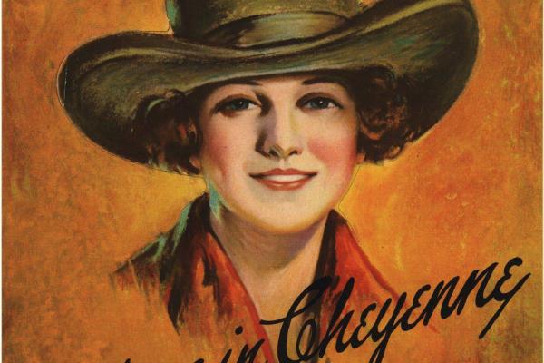 1928 poster with image of woman in cowboy hat, smiling. Text says "Meet me in Cheyenne; 32nd Annual Frontier Days. Bigger and Better Every Year."