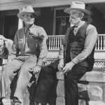 Stub, left, and Ed Farlow in front of Ed's house in Lander, Wyo., 1940s. The lamb was a pet. Lander Pioneer Museum.