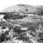 Independence Rock from the southwest, 1870. William Henry Jackson photo. The sandy swale in the trail in the foreground is now crossed by a low footbridge on the path from the highway rest area to the rock.