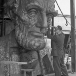 Robert Russin, right, and an assistant put finishing touches on the bronze head of Abraham Lincoln, 1959. UW photo service.