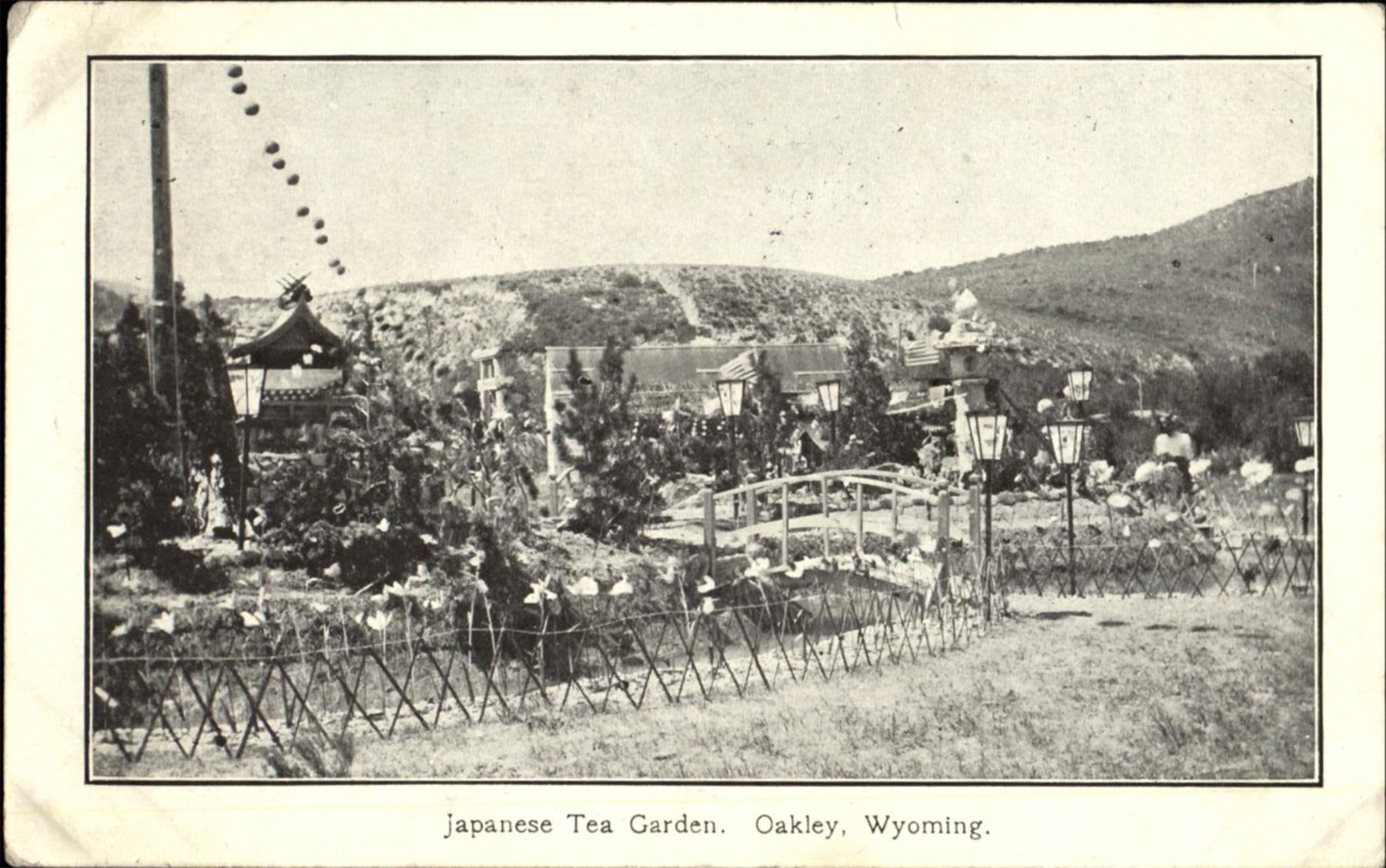 A postcard of a Japanese tea garden with an arched bridge, lanterns and ornamental fences at Oakley, Wyoming, a coal camp on the Oregon Short Line south of Kemmerer, ca. 1909. CardCow.com.