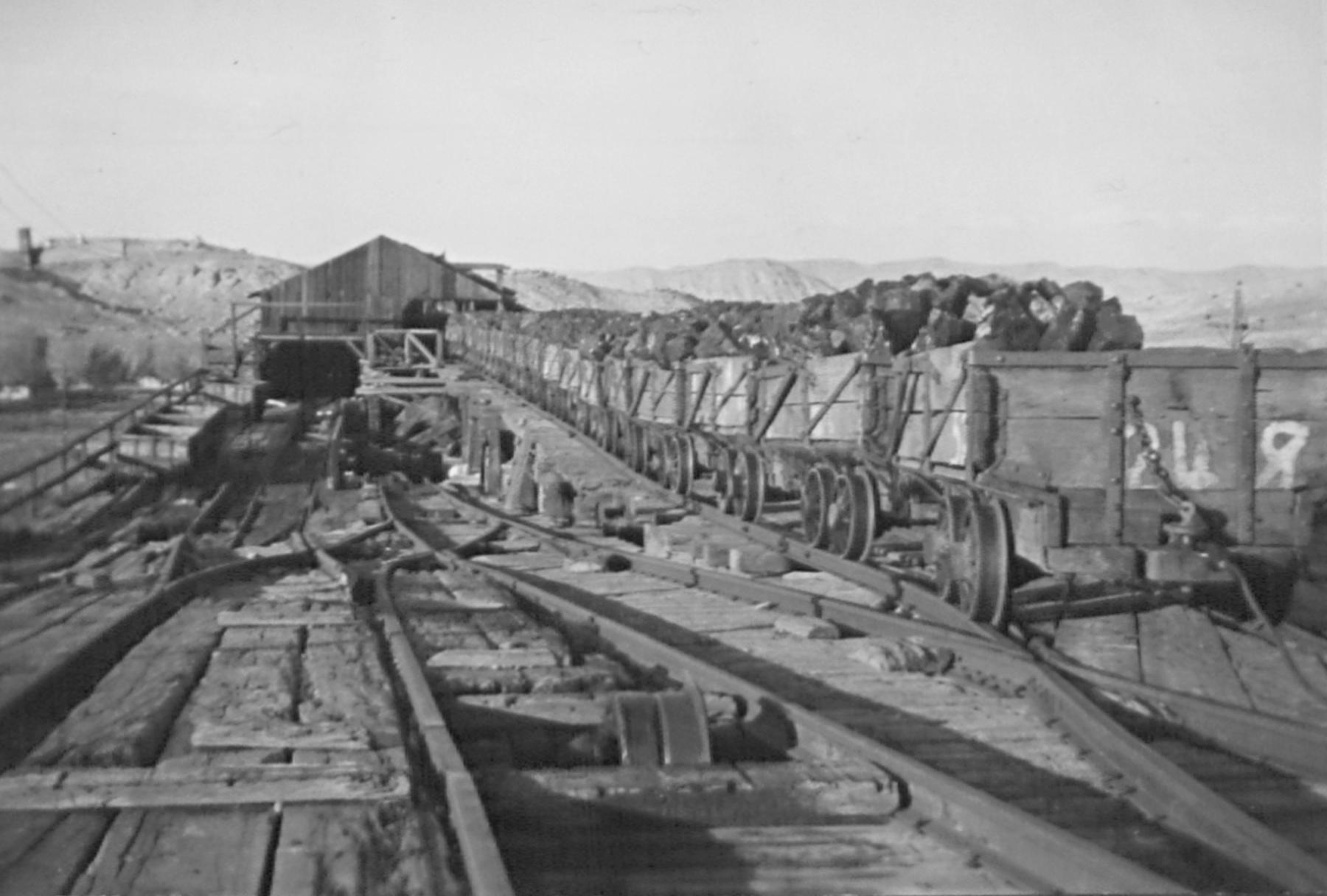 Loaded coal cars at the Gebo mine, lining up to be weighed. They will then be sent down the other track to the tipple so the coal can be sorted, then hauled to Kirby for shipment out to the world on the Burlington Railroad. American Heritage Center, University of Wyoming.