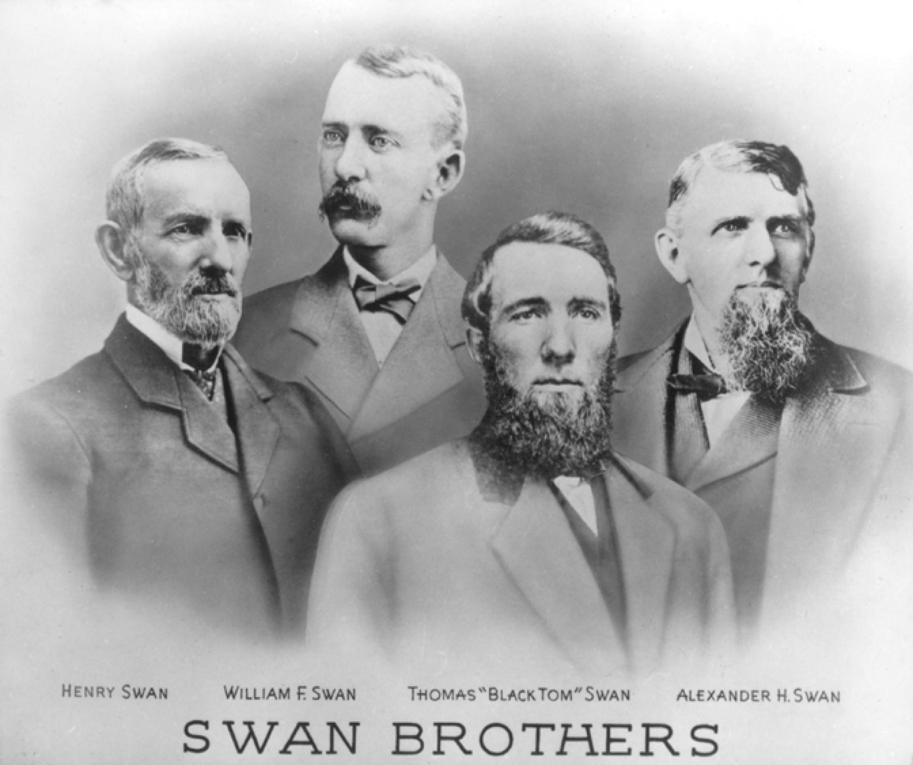 Portrait of four men in suits, each with moustache and/or beard