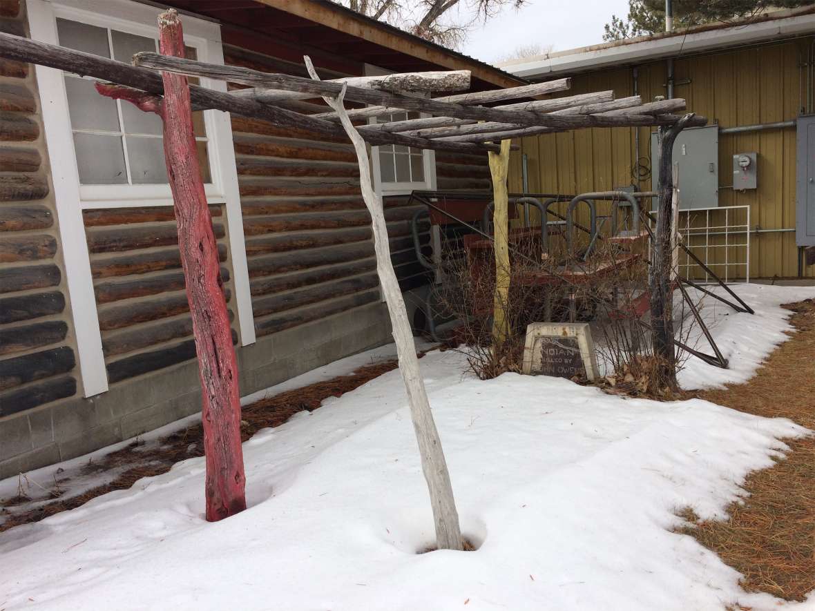 The grave of Black Kettle on the grounds of the Wyoming State Fair. It lies behind the log building that served for many years as the Fair’s musuem; a wall of the present museum is in the background. The scaffold was built for the 1938 reburial ceremony by carpenter Rick Anthony of Douglas. Tom Rea photo.