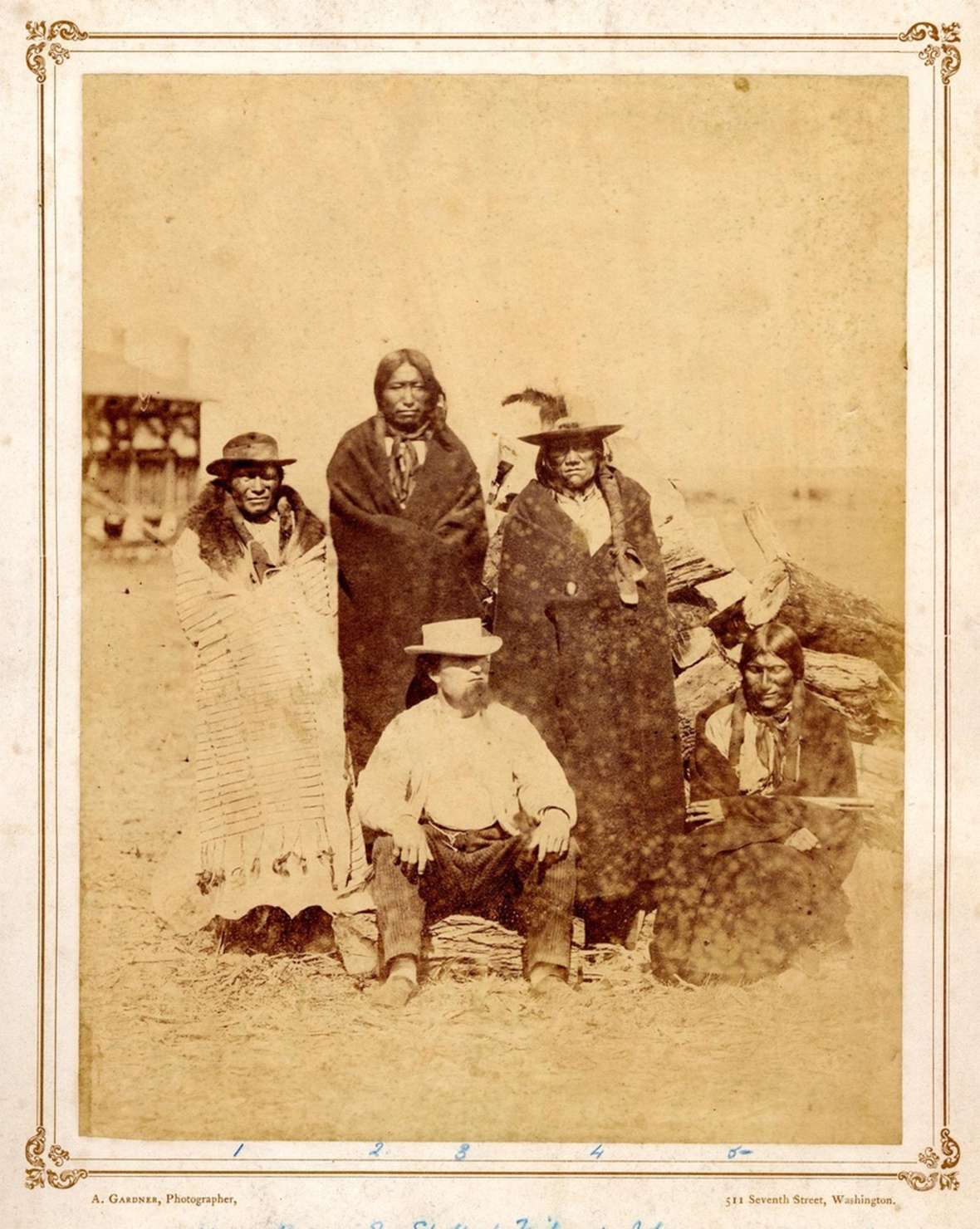 Fur trader Leon Pallardy sits in 1868 in front of the Lakota Sioux men, left to right, Fast Bear, Spotted Tail, John and Long Hair. Eight years earlier the census documented Pallardy living in civilian quarters next to Fort Laramie. Photo by Alexander Gardner. British Museum.