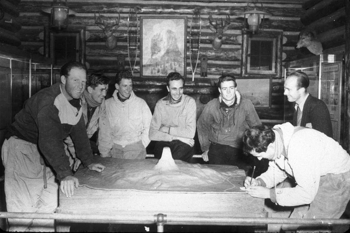 Jack Durrance (far right, leaning over the relief map) and his team plan Hopkins’s rescue in the Devils Tower visitor center. NPS photo.