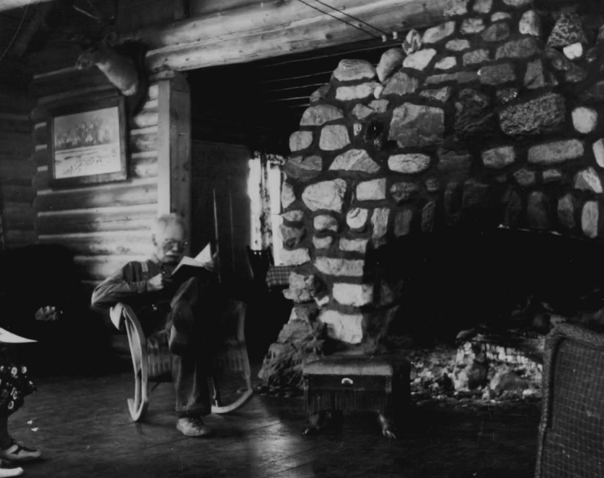 Leek reads a book inside his lodge, 1937, four years before his death. When the lodge burned in 1998, only the chimney survived, but it remains on the National Register of Historic Places. Wyoming SHPO.