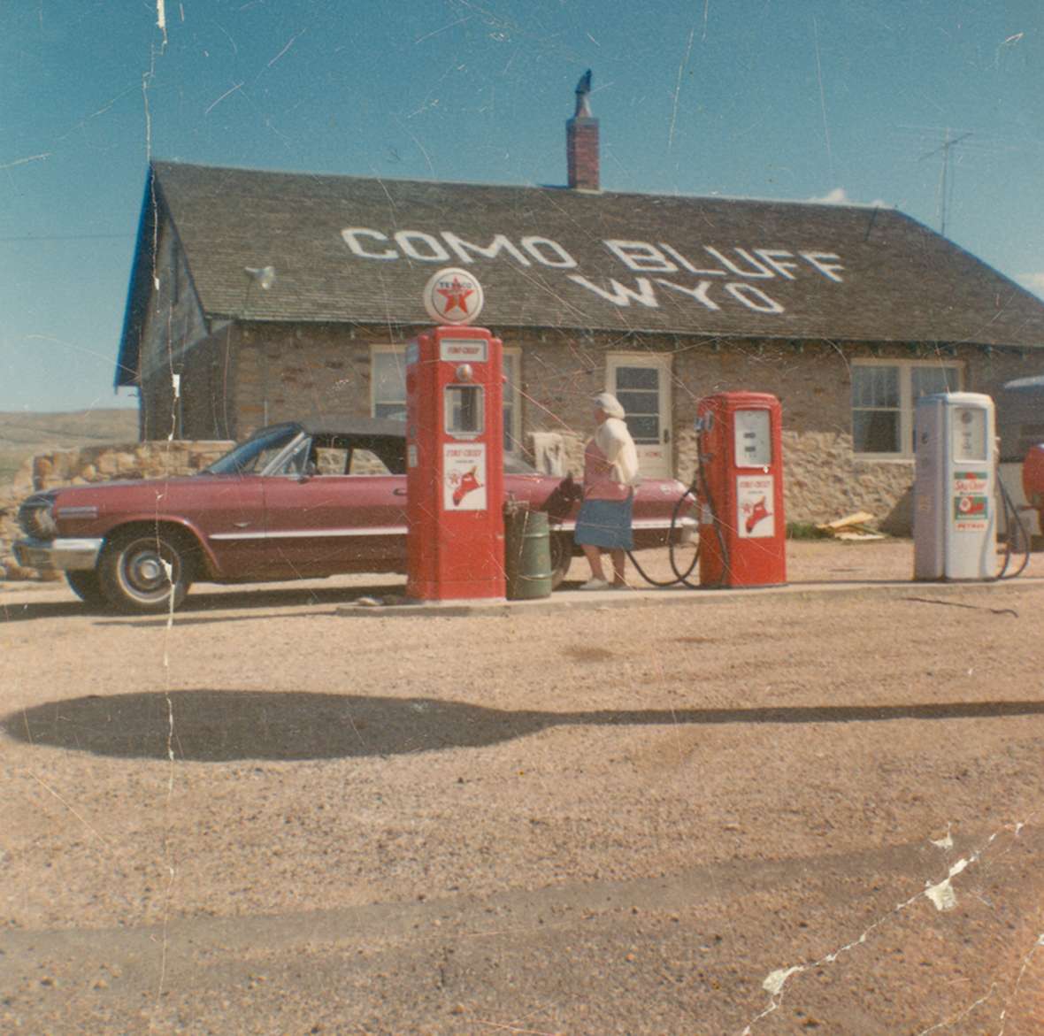 At Como Bluff east of Medicine Bow, the Boylan family in the 1930s built the famed 'fossil cabin' out of pieces of dinosaur bone and other fossils, together with this more conventional house. The roadside attraction and Texaco station continued operating into the 1970s—but after 1970, when Interstate 80 was completed, business would have contracted severely. Wyoming State Archives.