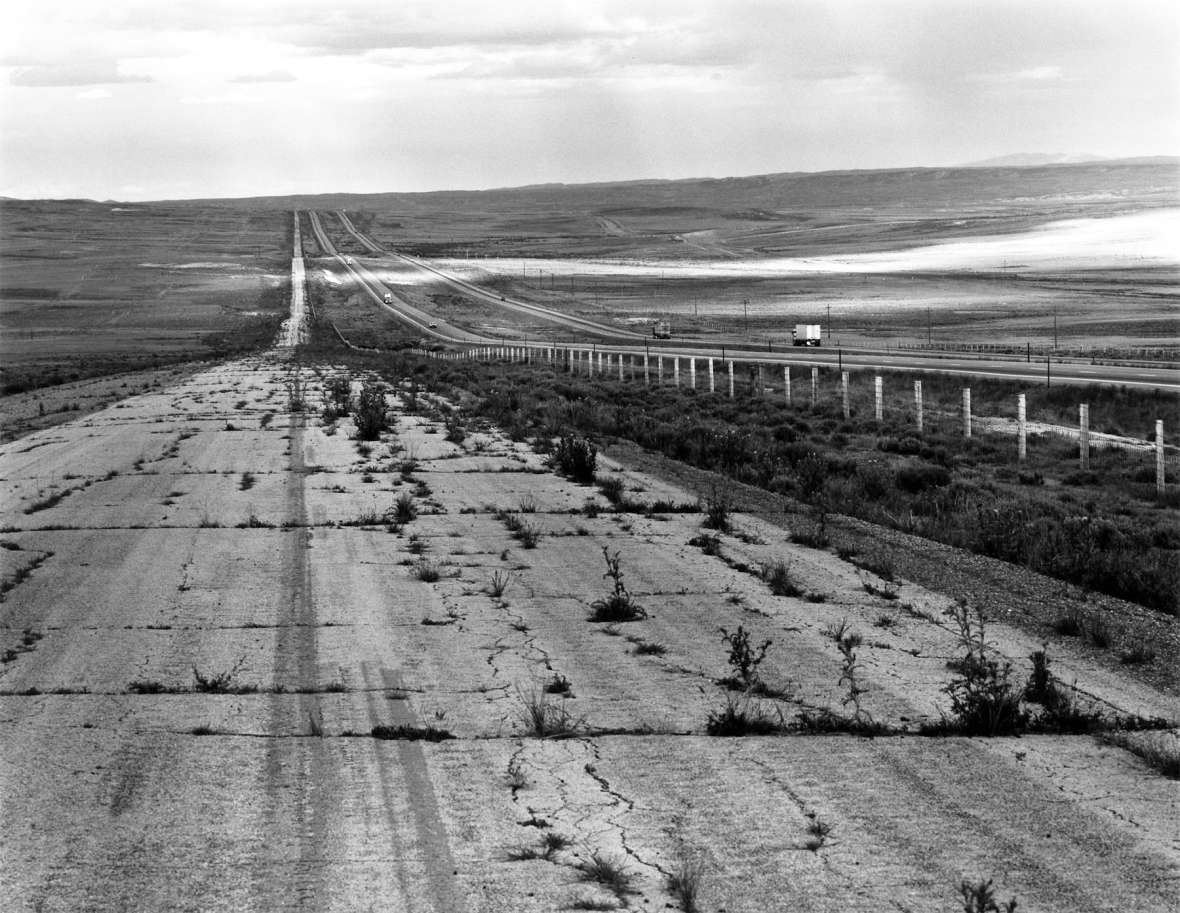 By the 1980s, when this photo was taken, grass was starting to grow through the cracks of the former U.S. 30, shown here in a stretch paralleling Interstate 80 near Creston, Wyo., and the Continental Divide. Drake Hokanson photo.