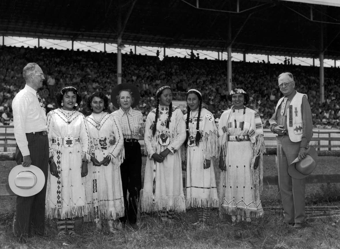 In 1953, the Freedoms Foundation of Valley Forge, Pa. awarded the Sheridan community a medal for ‘outstanding achievement’ in improving understanding between the American Indian and White races. Wyoming U.S. Representative William Henry Harrison and a committee of congressmen came to Sheridan in part to present the award at the first All-American Indian Day. Here, he stands at left with Lucy Yellowmule, Alta Driftwood, Mary Elizabeth Newton Harrison, Regina Spotted Horse, Joy Old Crow, Delores Little Coyote and Sheridan newspaperman and AAID founder Howard Sinclair. AAUW collection, SCFPL.