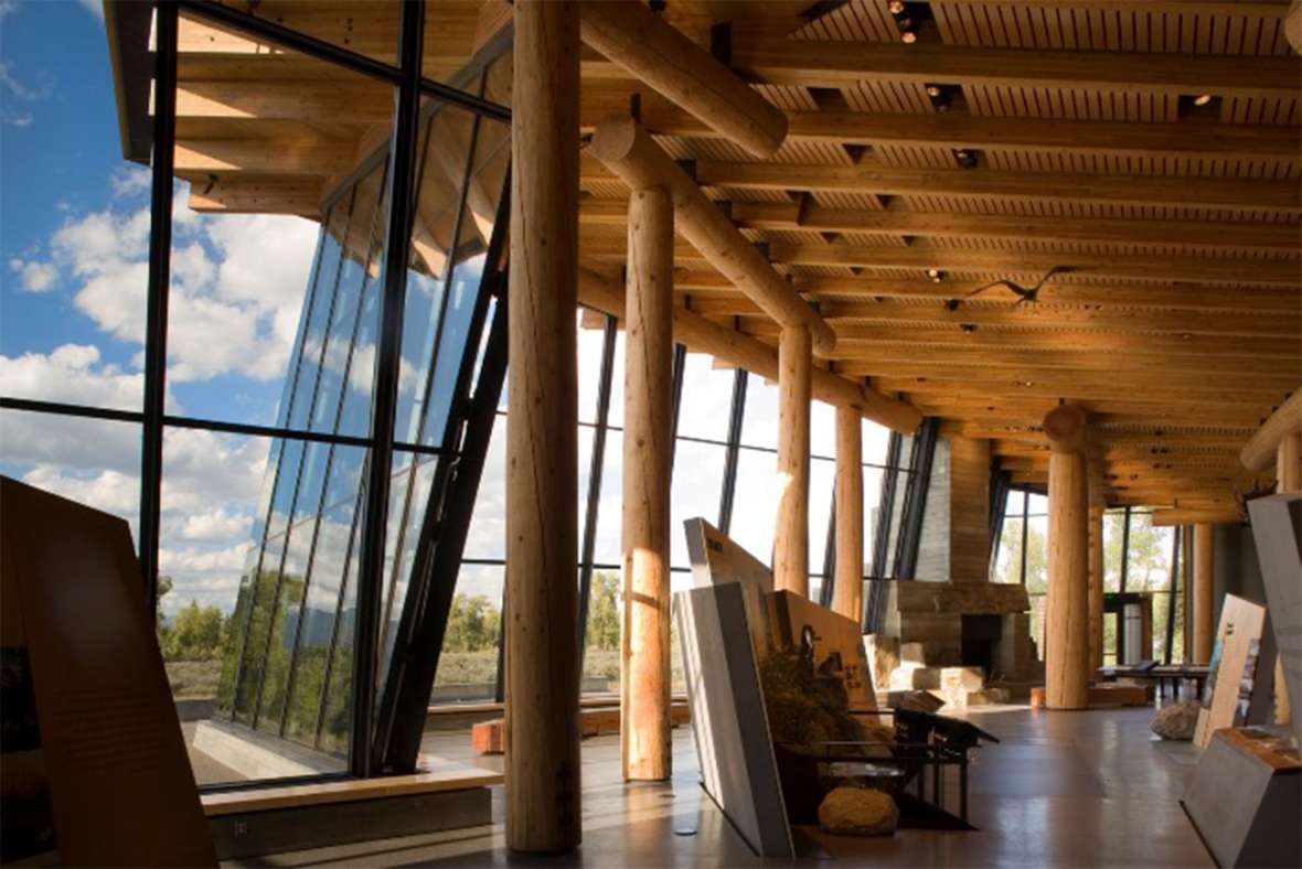 Even in buildings as recent as the 2007 visitor center in Grand Teton National Park, parkitecture’s long-lived influence shows in features like the raw wood pillars and beams, and the focus on the natural setting. GNTNPF photo.