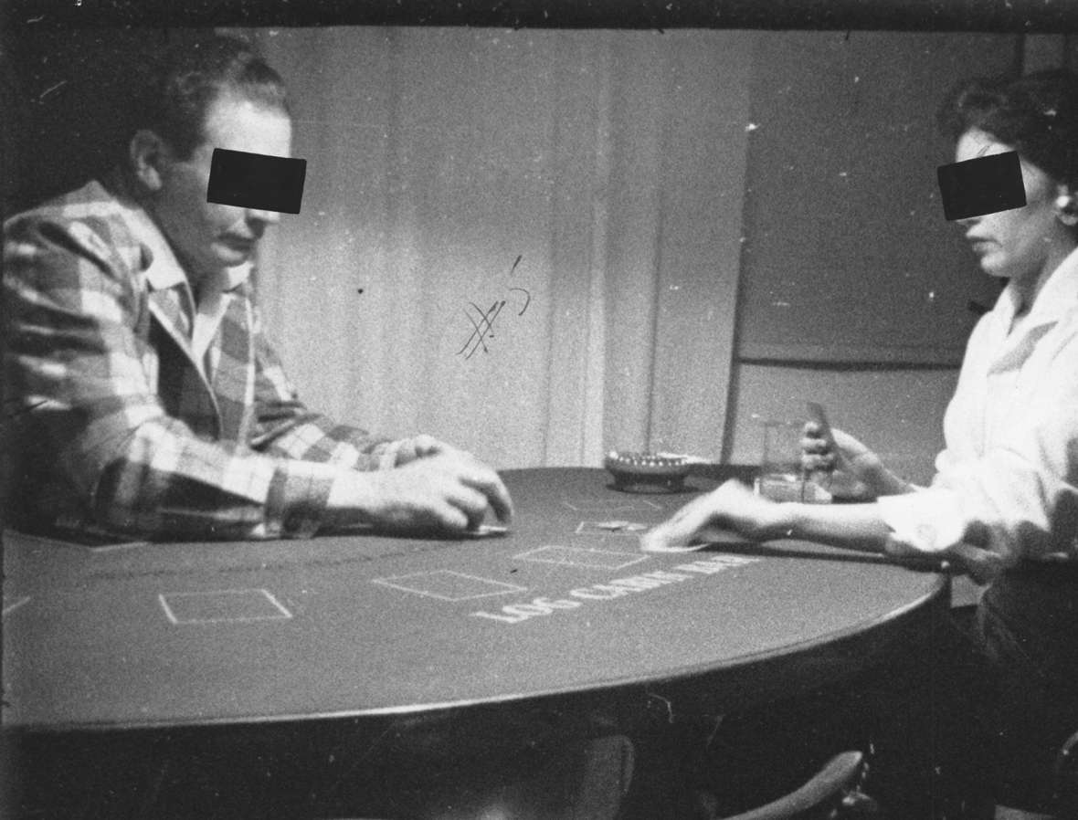 Gov. Simpson’s decision to crack down on illegal gambling in Jackson appears to have cost him heavily in Teton County when he ran for re-election. Shown here, a pair of anonymous card players in Jackson, 1956. American Heritage Center.