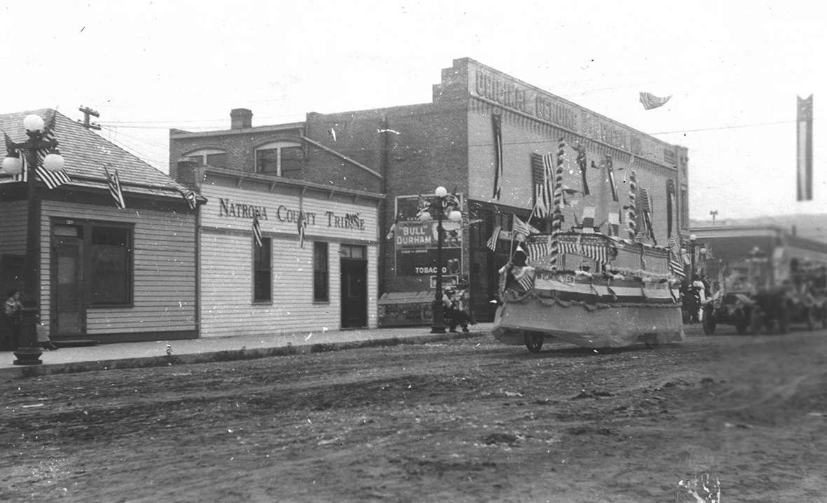 A parade through downtown Casper, Wyo., about 1910, with a float modeled on the battleship 'Wyoming.' Fort Caspar Museum collections. 