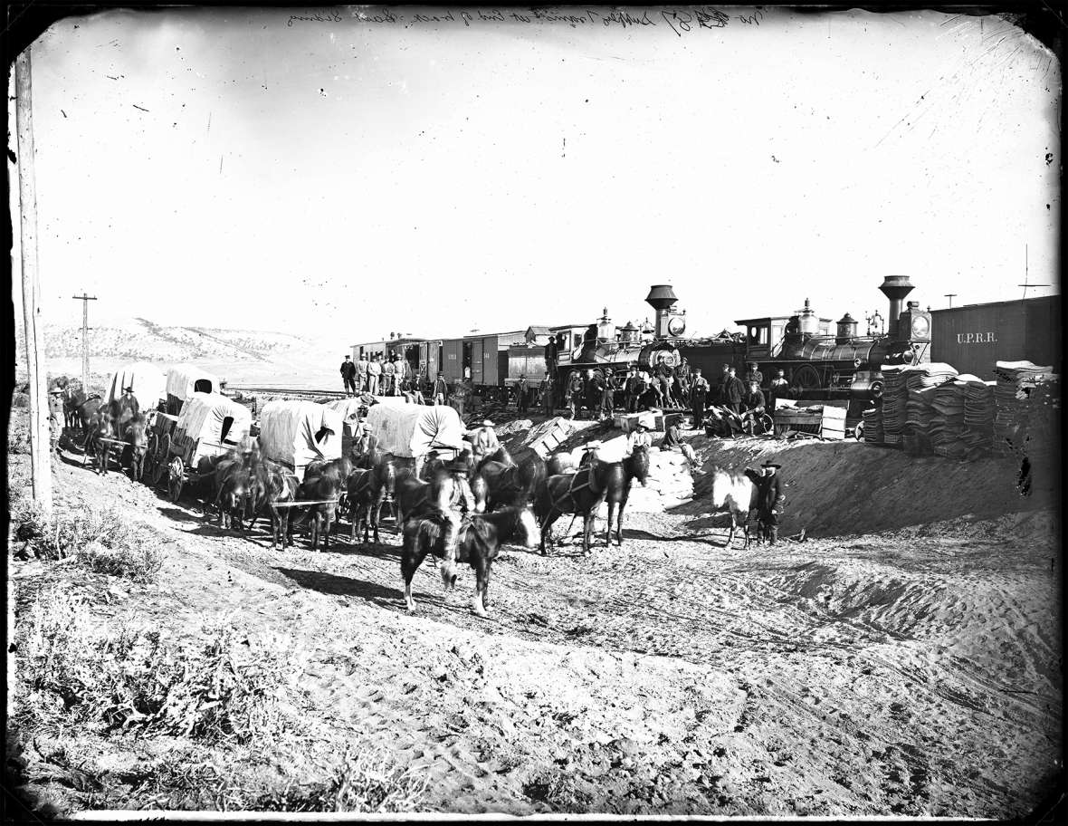 Freighters wait with teams and wagons to pick up construction supplies at the end of the Union Pacific tracks, 1868. The Trabing brothers arrived that year in Laramie, and soon began freighting goods from the railroad to far-flung parts of Wyoming Territory. A.J. Russell photo.