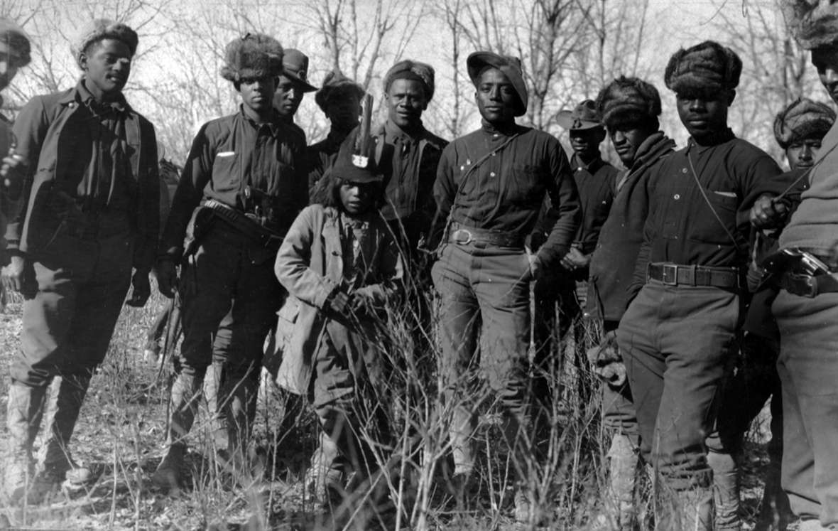 Units of the Tenth Cavalry, stationed at Fort Robinson in Nebraska, were the first sent by the Army after the Utes. Shown here, some of the buffalo soldiers in camp on Powder River, with a Ute friend. T.W. Tolman photo, Northwest Museum of Arts and Culture.