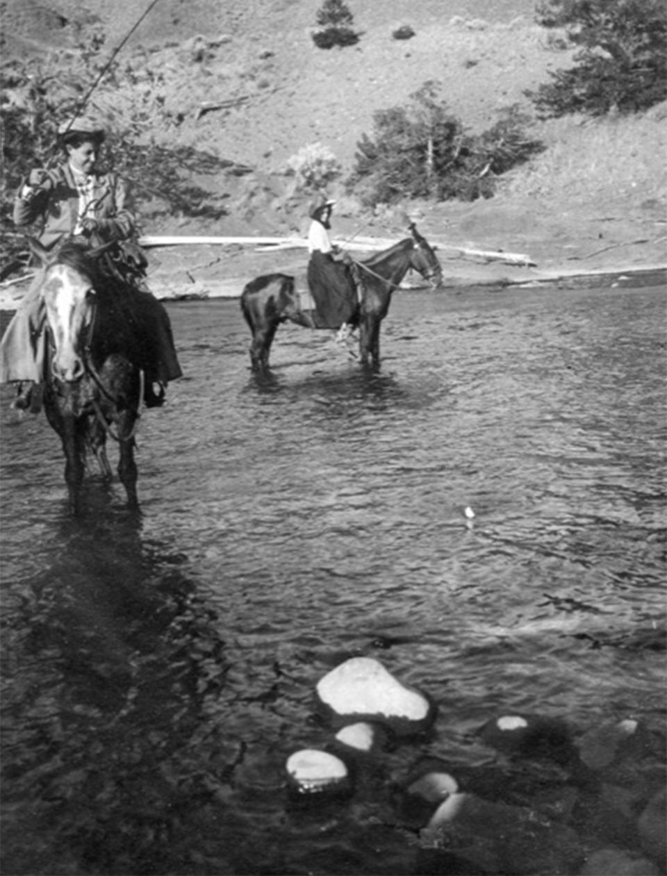 Early Wyoming outfitters took their clients on fishing excursions, which included guide services and tackle. Here, women fish from horseback in Yellowstone National Park. Ned Frost photo. Courtesy Bob Richard.