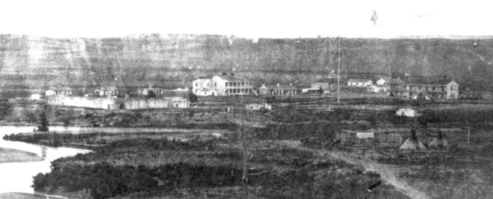 extrmemly blurry image of some one- and two-story buildings near a river