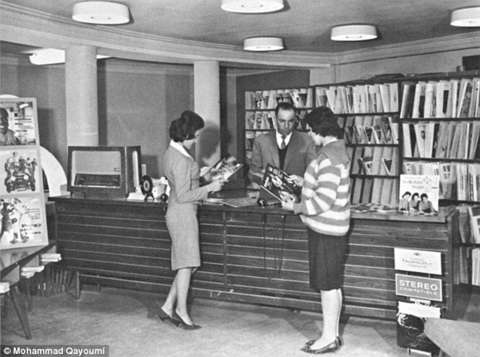 Above, Afghan women browse in a record store, 1960s; below, women students in a biology lab at Kabul University. These photos were remarkable at the time for showing women in western clothing and in the same room as men who were not members of their family. The images are from a photobook published by the Afghan planning ministry in the l1960s and republished by Mohammed Qayoumi in a 2010 photo essay in Foreign Policy magazine. Qayoumi grew up in Kabul in the 1950s and ‘60s. American Heritage Center, University of Wyoming.