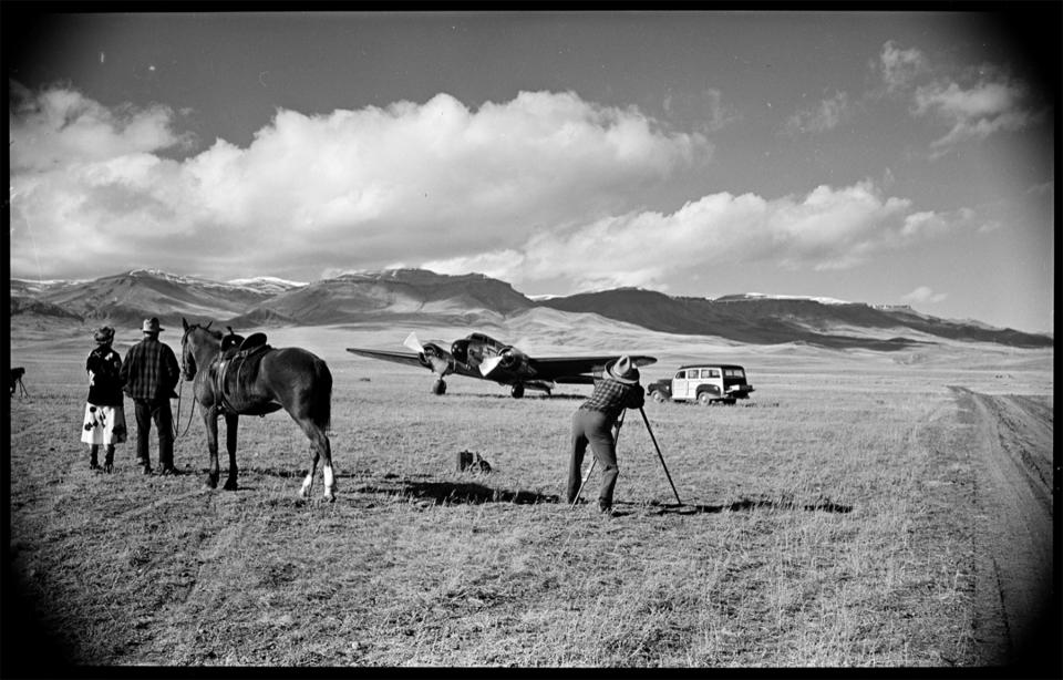 Belden loved to combine images of the new West with the old. Here, he photographs a twin-engine airplane while a pair of dudes look on. Buffalo Bill Center of the West.