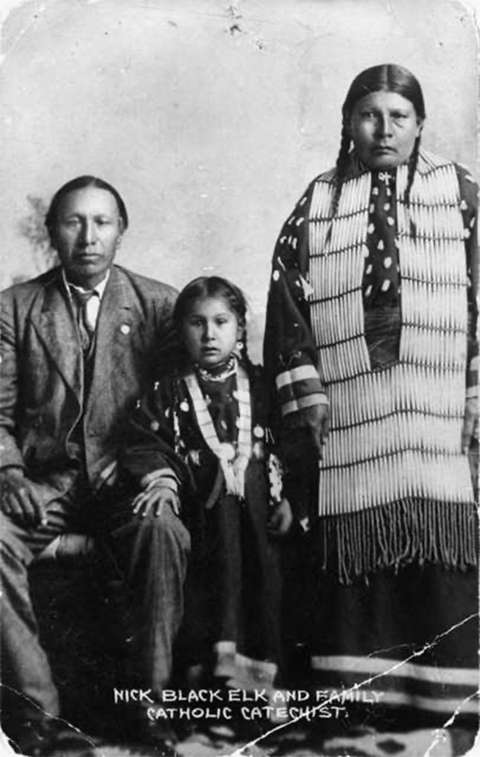 Black Elk took the first name Nicholas during his years as a catechist for the Catholic Church. Here he is with his daughter, Lucy, and wife, Anna Brings White, at their home in Manderson, So. Dak., on the Pine Ridge Reservation about 1910. Wikipedia.