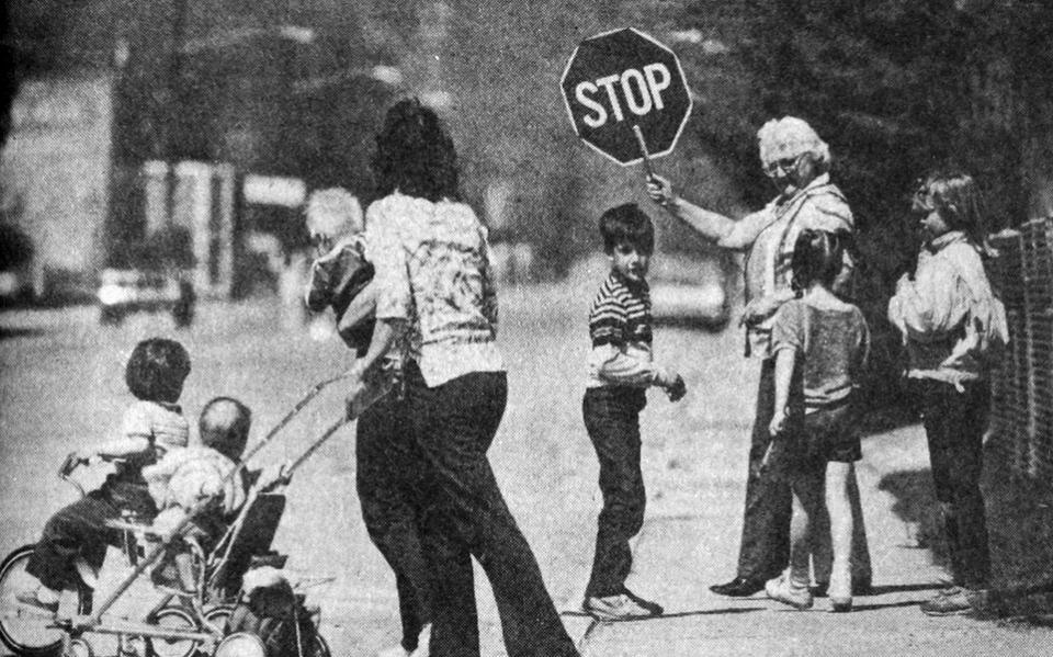 Buhla Teichert helps pedestrians cross the street as Cokeville returns to normal after the bombing. Bill Wilcox photo,  Casper Star-Tribune Collection, Casper College Western History Center.