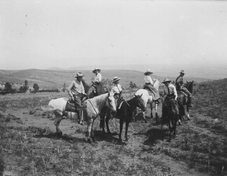 Dudes enjoy each other and the the view from a ridgetop above Eatons' Ranch west of Sheridan, ca. 1920. American Heritage Center.