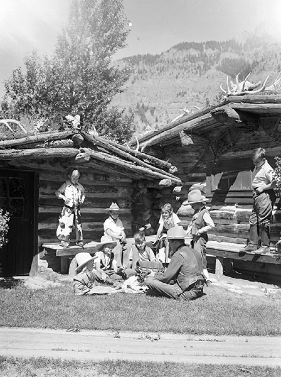 Larry Larom  entertains young customers on the Valley Ranch in the 1930s. Charles Belden photo, American Heritage Center.