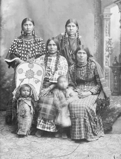 Kate Enos, top left, with her sisters Louisa Enos Wesaw, Mary Enos Rabbittail, and Emma Enos Lewis. The baby in the cradle board is thought to be Antoine Weed, and the little girl standing, Sousanna Weed. Both are Mary Enos Rabbittail’s children. American Heritage Center via Sweetwater County Historical Museum.