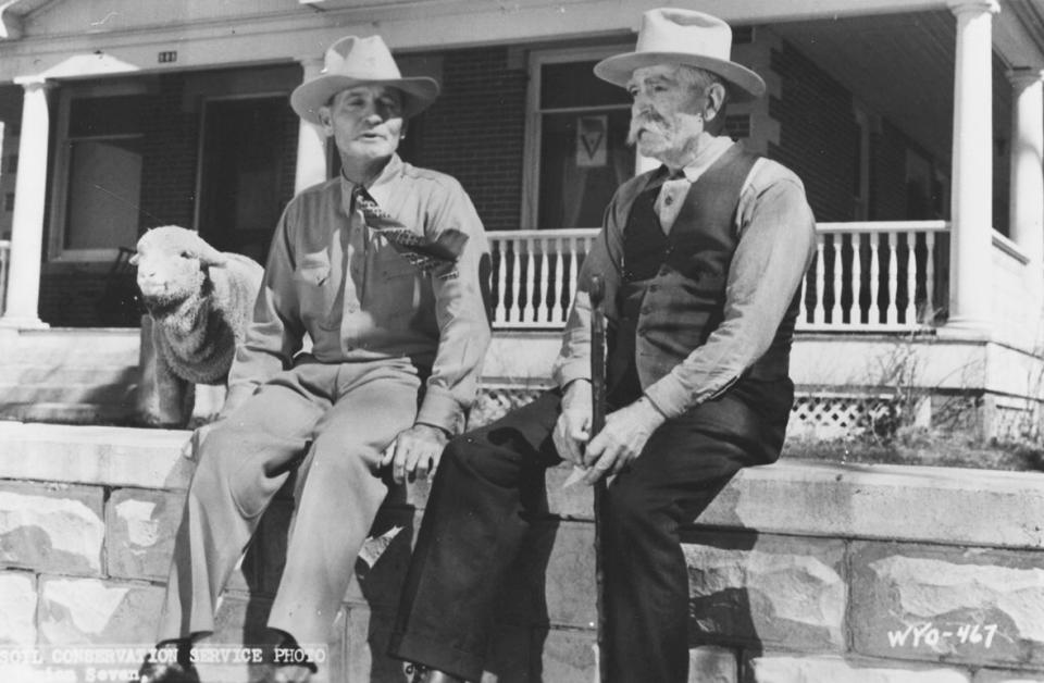 Stub, left, and Ed Farlow in front of Ed's house in Lander, Wyo., 1940s. The lamb was a pet. Lander Pioneer Museum.