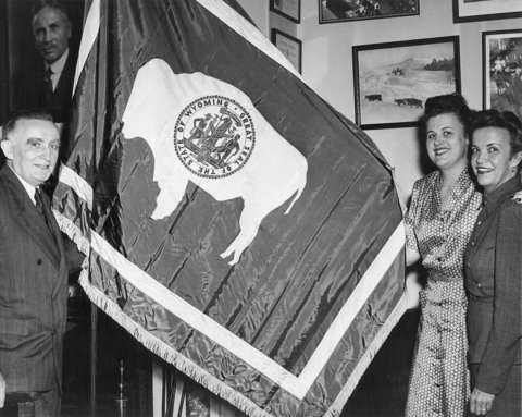 Wyoming’s U.S. senator Joseph O’Mahoney, left, and two staffers, one of them probably Margaret Cordiner Vendel, in O’Mahoney’s office in the 1940s. Above the senator’s head is a portrait of Senator, formerly Governor John B. Kendrick, who had signed the flag design into state law in 1917. In this version, the bison faces the pole— by that time the standard design. Wyoming State Archives.