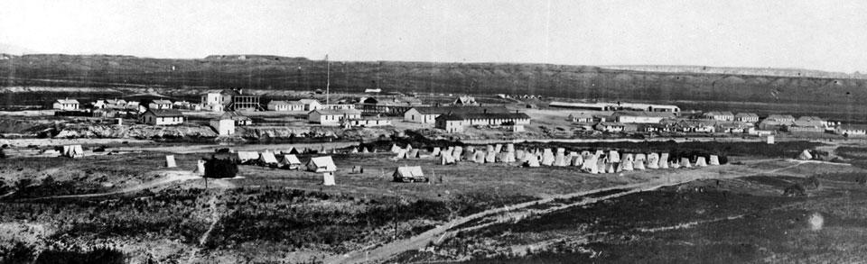 William Henry Jackson took this photo of Fort Laramie in 1870 during its peak years as an army post. Note the flagpole left of center and the two-story porch of Old Bedlam, the bachelor offiers' quarters, left of the flagpole. USGS photo library.