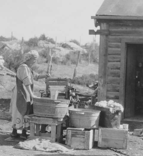 Ethel Waxham Love on laundry day, 1917, at the family’s new gasoline-powered Maytag washing machine. Love family photo.