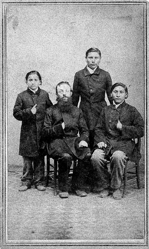 Cheyenne boys Brown Moccasin, Little Bone and Owl Head arrived with their Lutheran custodians at Wartburg Seminary near Dubuque, Iowa, late in 1864, after the Lutherans failed in a multi-year attempt to establish missions in what’s now Wyoming. Shown here are the three boys that year—it’s unrecorded which is which—with missionary Karl Krebs. Samuel Root photo, Wartburg Theological Seminary Archives.