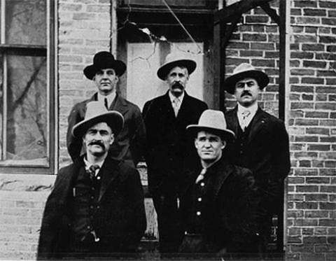 Defendants in the Spring Creek Raid case outside the Big Horn County Courthouse in Basin, Wyo.. Clockwise from top left: Herb Brink, Ed Eaton, George Saban, Tom Dixon, Milton Alexander. Washakie Museum photo.