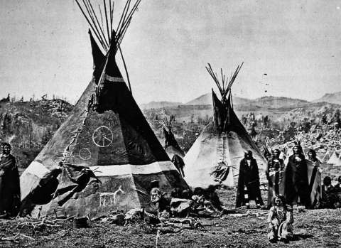An Eastern Shoshone village near South Pass, 1870. The tipi at front bears an image of what may be the Medicine Wheel. W.H. Jackson photo.