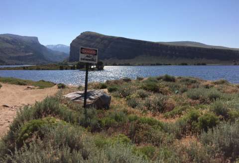 In recent decades, rehab work has begun on heagates, ditches and other irrigation structures on the Little Wind River. Above, Washakie Reservoir on the South Fork of the Little Wind and below, the reservoir's dam. Both are about five miles west of Fort Washakie, Wyo. Tom Rea.