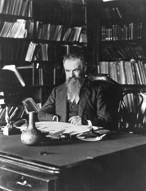 John Wesley Powell at his desk in Washington, D.C., in 1896. Under intense pressure from his political enemies, he had resigned his directorship of the U.S. Geological Survey two years earlier, but stayed on as head of the U.S. Bureau of Ethnology. Wikipedia.