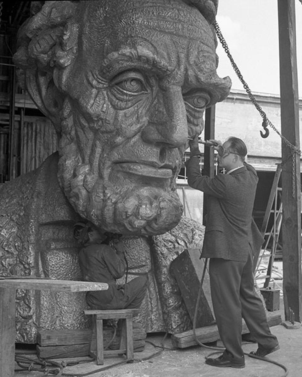 Robert Russin, right, and an assistant put finishing touches on the bronze head of Abraham Lincoln, 1959. UW photo service.