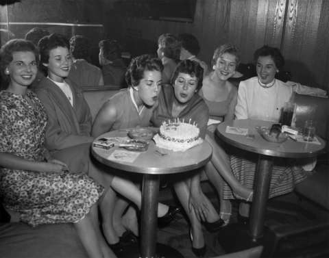 Pat Sloan of Louisville, Ky., center left, and Ann Dempsey of Seattle, center right, celebrate their birthdays in June 1958 with other trainee friends at the Wigwam Lounge in the Plains Hotel, Cheyenne, a favorite trainee meeting place at the time. Wyoming State Archives.