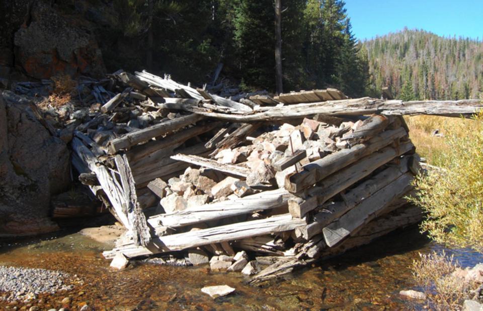 Before entering the flume, ties were held in log dams.  The remains of the Warm Spring holding dams—four rock-filled log cribs—are located about 300 yards south of the bridge over Warm Spring Creek on the Union Pass Road. E. Rosenberg, 2010.